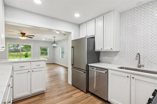 1436 NW 97th St, Oklahoma City, OK 73114 - kitchen with stainless steel appliances, decorative backsplash, white cabinetry, light countertops, and recessed lighting