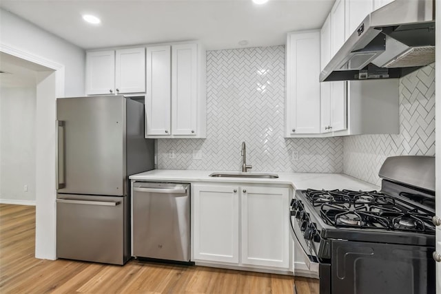 1436 NW 97th St, Oklahoma City, OK 73114 - kitchen featuring appliances with stainless steel finishes, range hood, white cabinetry, light countertops, and recessed lighting