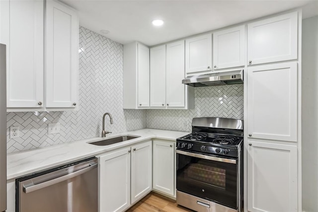1436 NW 97th St, Oklahoma City, OK 73114 - kitchen featuring dishwasher, gas range oven, under cabinet range hood, tasteful backsplash, and white cabinets