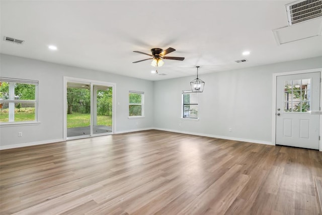 1436 NW 97th St, Oklahoma City, OK 73114 - unfurnished living room featuring plenty of natural light, recessed lighting, light wood finished floors, and ceiling fan
