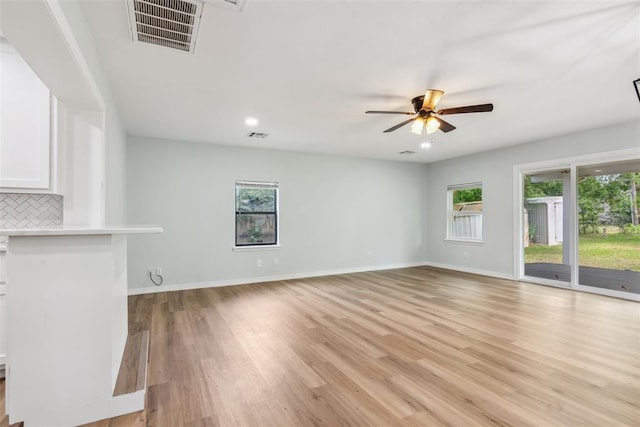 1436 NW 97th St, Oklahoma City, OK 73114 - unfurnished living room featuring a ceiling fan, light wood-type flooring, and recessed lighting