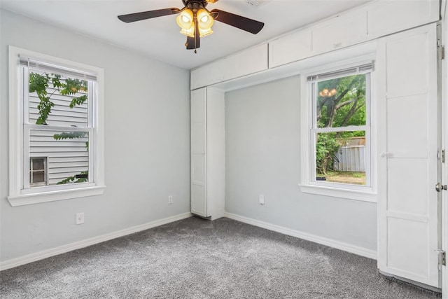 1436 NW 97th St, Oklahoma City, OK 73114 - unfurnished bedroom with carpet, multiple windows, and ceiling fan