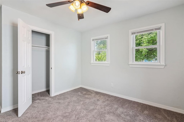 1436 NW 97th St, Oklahoma City, OK 73114 - unfurnished bedroom featuring light colored carpet, multiple windows, a closet, and a ceiling fan