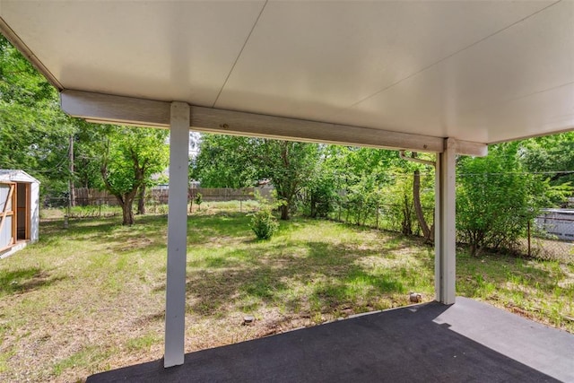 1436 NW 97th St, Oklahoma City, OK 73114 - fenced backyard with a patio area and a storage unit