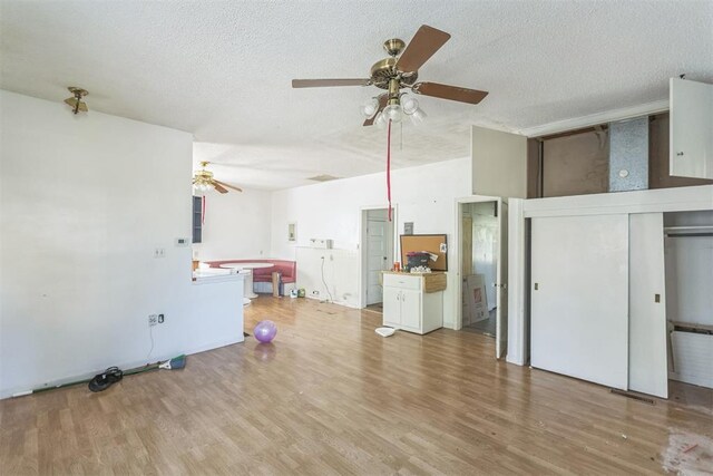 400 E Wagner Ave, Pauls Valley, OK 73075 - unfurnished living room with ceiling fan, a textured ceiling, and wood finished floors