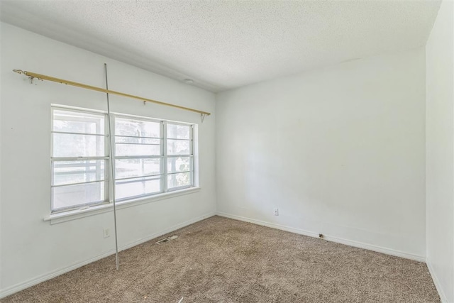 400 E Wagner Ave, Pauls Valley, OK 73075 - carpeted empty room featuring a textured ceiling and baseboards