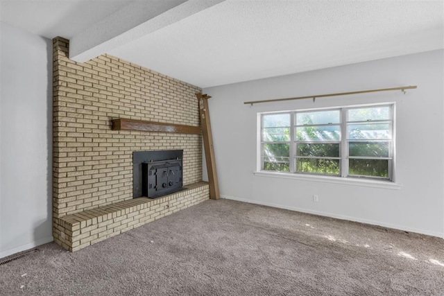 400 E Wagner Ave, Pauls Valley, OK 73075 - unfurnished living room featuring carpet flooring, beamed ceiling, and a textured ceiling