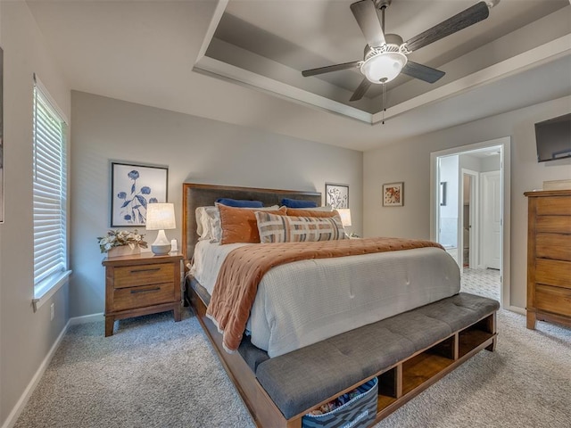 4116 Armstead Ave, Edmond, OK 73012 - carpeted bedroom with a tray ceiling, multiple windows, and a ceiling fan