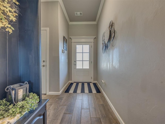 4116 Armstead Ave, Edmond, OK 73012 - doorway with wood finished floors and ornamental molding