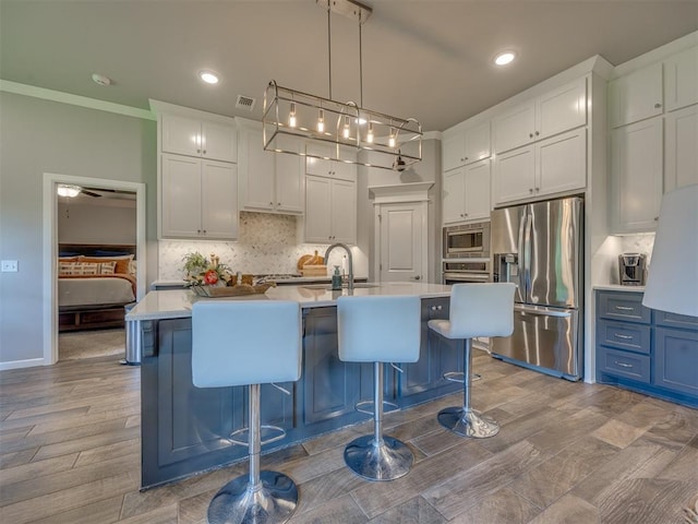 4116 Armstead Ave, Edmond, OK 73012 - kitchen with appliances with stainless steel finishes, light countertops, tasteful backsplash, white cabinets, and recessed lighting