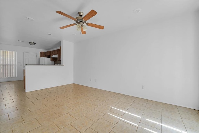 1501 N Wade St, Sayre, OK 73662 - unfurnished living room featuring ceiling fan and light tile patterned floors