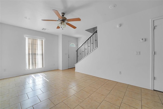 1501 N Wade St, Sayre, OK 73662 - empty room with ceiling fan, light tile patterned floors, stairs, and a smoke detector