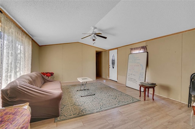 11567 N 1790th Rd, Sayre, OK 73662 - living area featuring a ceiling fan, a textured ceiling, vaulted ceiling, light wood-type flooring, and crown molding