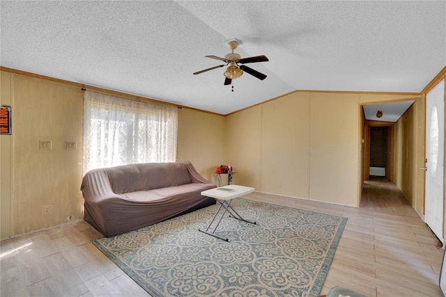 11567 N 1790th Rd, Sayre, OK 73662 - living area featuring a ceiling fan, lofted ceiling, light wood-style floors, a textured ceiling, and ornamental molding
