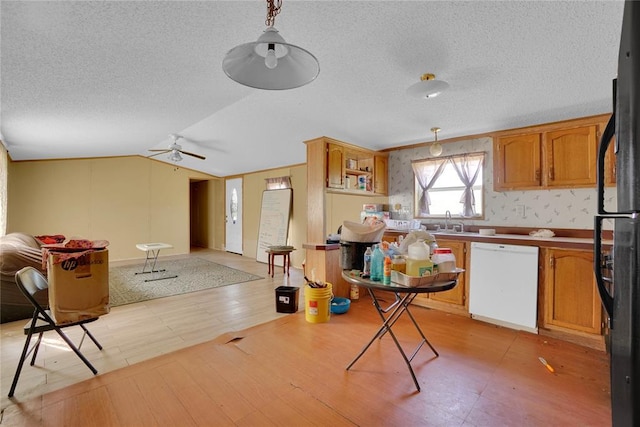 11567 N 1790th Rd, Sayre, OK 73662 - kitchen featuring dishwasher, open floor plan, a ceiling fan, freestanding refrigerator, and a textured ceiling
