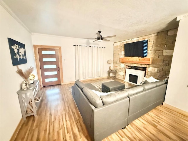 717 E Walnut St, Altus, OK 73521 - living room with wood finished floors, a fireplace, ceiling fan, and crown molding