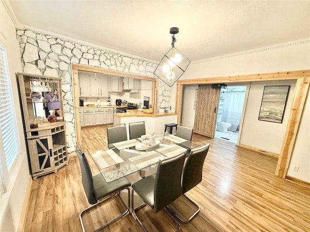 717 E Walnut St, Altus, OK 73521 - dining space with ornamental molding and light wood-style flooring