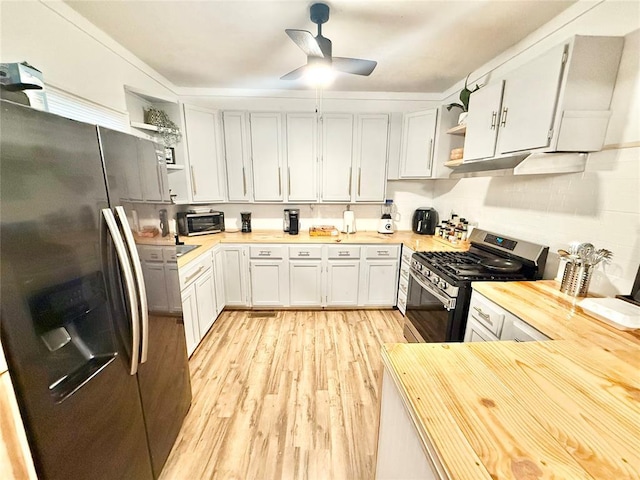 717 E Walnut St, Altus, OK 73521 - kitchen with stainless steel appliances, open shelves, light wood-style flooring, ceiling fan, and under cabinet range hood