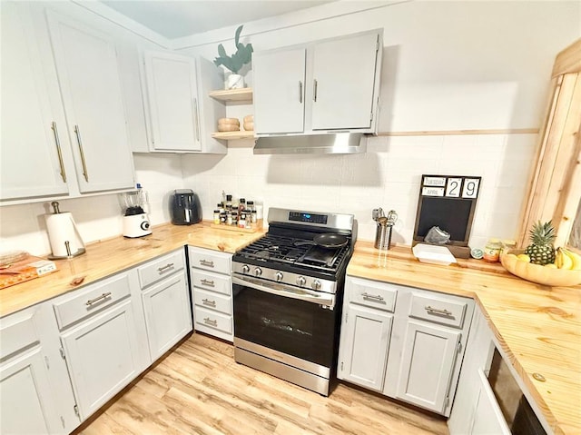 717 E Walnut St, Altus, OK 73521 - kitchen featuring stainless steel gas range, under cabinet range hood, wood counters, open shelves, and light wood finished floors