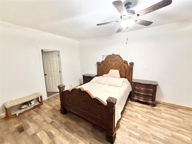 717 E Walnut St, Altus, OK 73521 - bedroom with wood finished floors and a ceiling fan