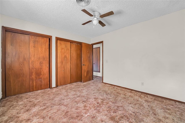 418 N Electra St, Sayre, OK 73662 - unfurnished bedroom with two closets, carpet, a textured ceiling, and a ceiling fan