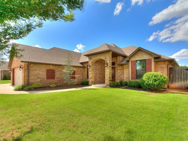 12105 SW 45th Ter, Mustang, OK 73064 - single story home featuring a garage, brick siding, a shingled roof, and driveway