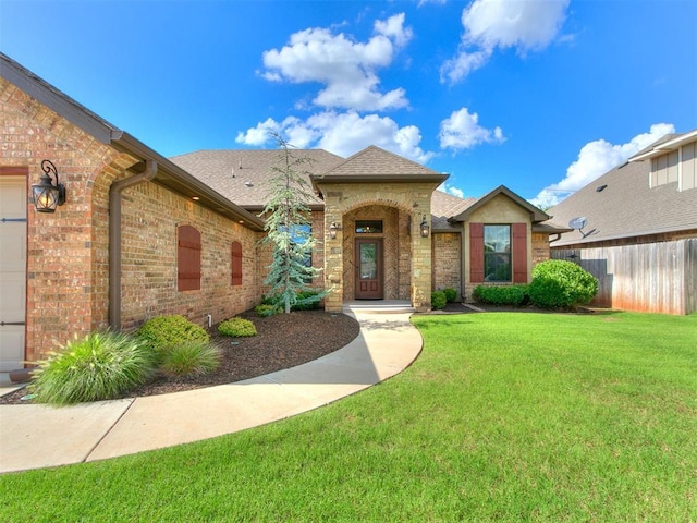 12105 SW 45th Ter, Mustang, OK 73064 - view of front of house with brick siding and a shingled roof