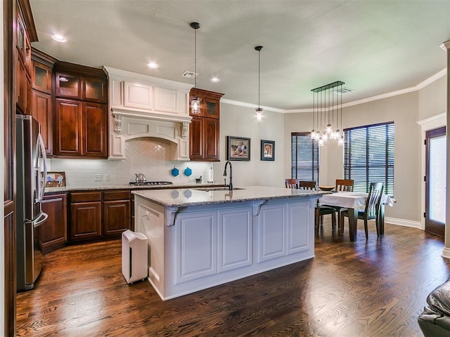 12105 SW 45th Ter, Mustang, OK 73064 - kitchen with appliances with stainless steel finishes, a chandelier, decorative backsplash, light stone counters, and dark wood finished floors