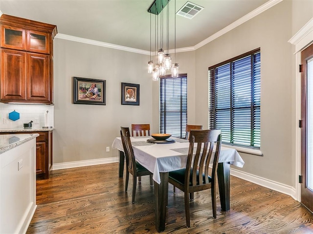 12105 SW 45th Ter, Mustang, OK 73064 - dining space with dark wood-type flooring, crown molding, and a chandelier