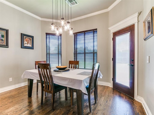 12105 SW 45th Ter, Mustang, OK 73064 - dining room featuring dark wood-style flooring and crown molding