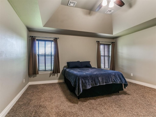 12105 SW 45th Ter, Mustang, OK 73064 - bedroom featuring carpet flooring, a ceiling fan, and a tray ceiling
