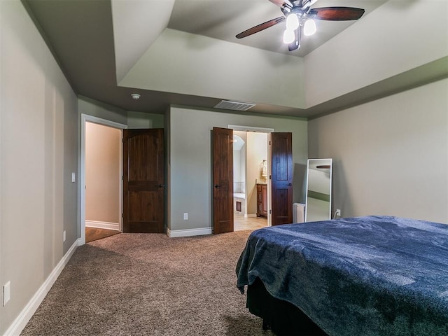 12105 SW 45th Ter, Mustang, OK 73064 - bedroom featuring light colored carpet, ensuite bathroom, and ceiling fan