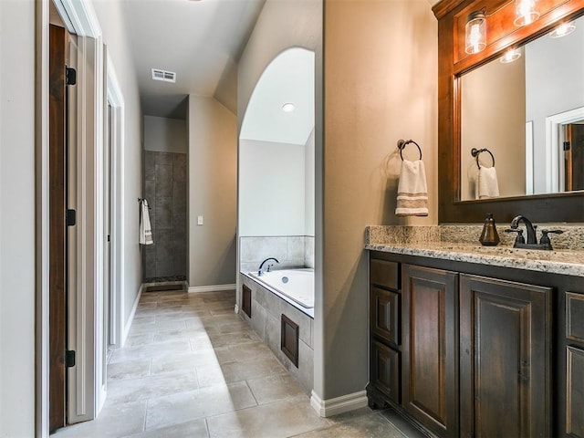 12105 SW 45th Ter, Mustang, OK 73064 - full bathroom featuring vanity, a bath, tiled shower, and tile patterned floors