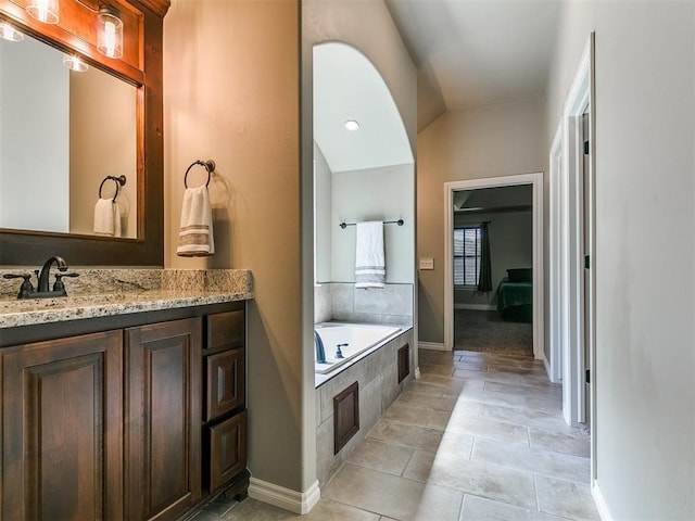 12105 SW 45th Ter, Mustang, OK 73064 - ensuite bathroom featuring a garden tub, vanity, and tile patterned flooring