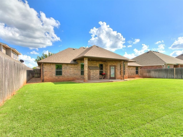 12105 SW 45th Ter, Mustang, OK 73064 - rear view of property with brick siding, a fenced backyard, a patio, and roof with shingles