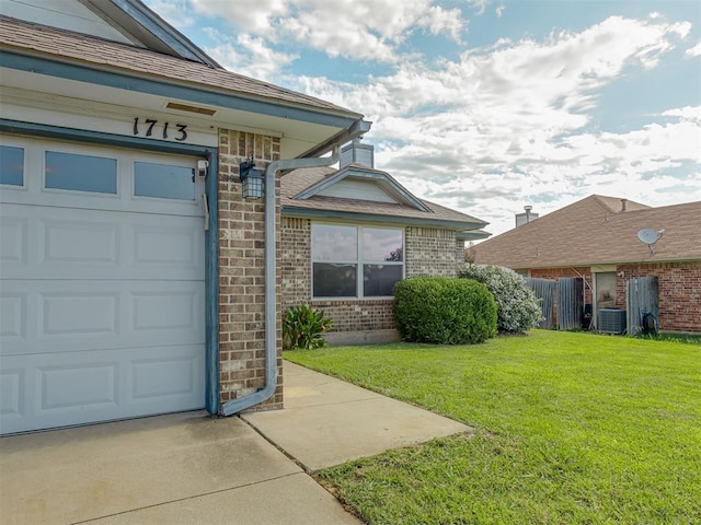 1713 SE 14th St, Moore, OK 73160 - view of exterior entry featuring brick siding, a garage, and concrete driveway