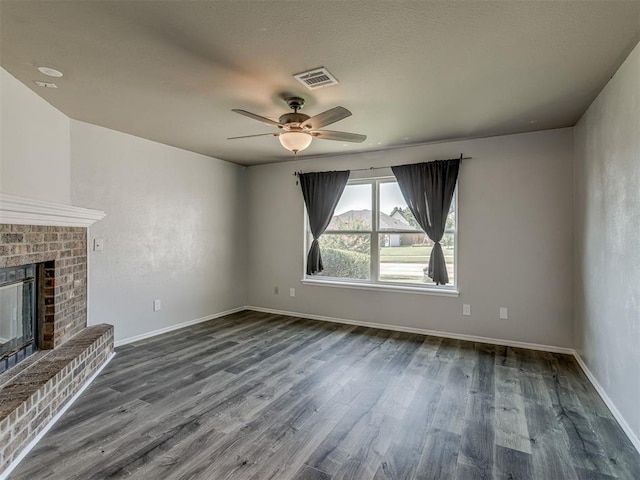 1713 SE 14th St, Moore, OK 73160 - unfurnished living room featuring dark wood-type flooring, a ceiling fan, and a brick fireplace