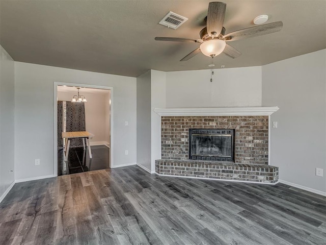 1713 SE 14th St, Moore, OK 73160 - unfurnished living room with wood finished floors, a ceiling fan, and a chandelier