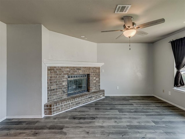 1713 SE 14th St, Moore, OK 73160 - unfurnished living room with ceiling fan, wood finished floors, and a brick fireplace