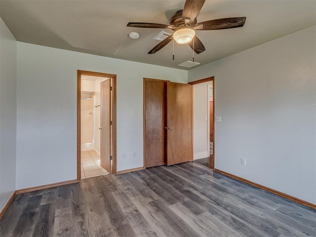 1713 SE 14th St, Moore, OK 73160 - unfurnished bedroom featuring wood finished floors, ensuite bath, and a ceiling fan