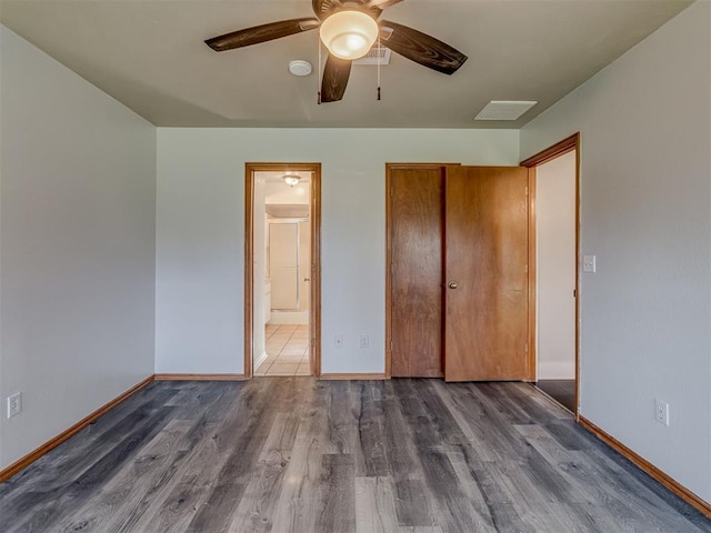 1713 SE 14th St, Moore, OK 73160 - unfurnished bedroom with wood finished floors, a closet, ceiling fan, and ensuite bathroom
