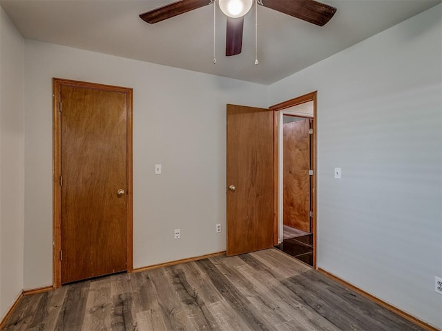 1713 SE 14th St, Moore, OK 73160 - unfurnished bedroom featuring wood finished floors and a ceiling fan