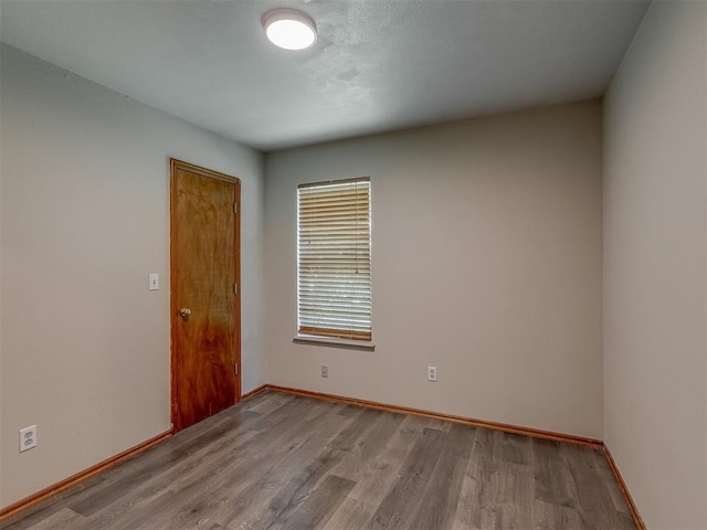 1713 SE 14th St, Moore, OK 73160 - unfurnished room with wood finished floors and baseboards