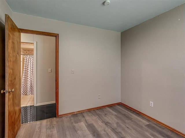 1713 SE 14th St, Moore, OK 73160 - empty room with wood finished floors and baseboards