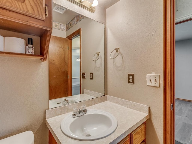 1713 SE 14th St, Moore, OK 73160 - bathroom with vanity and a textured wall