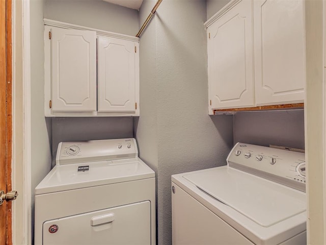 1713 SE 14th St, Moore, OK 73160 - laundry area with washing machine and clothes dryer, cabinet space, and a textured wall