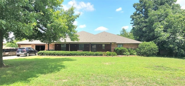 1117 Moose St, Yukon, OK 73099 - back of house featuring an attached garage, a yard, and brick siding