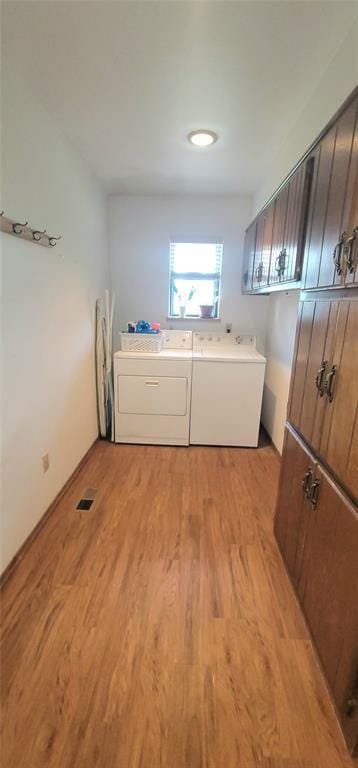 1117 Moose St, Yukon, OK 73099 - laundry area with light wood-style flooring and washing machine and dryer