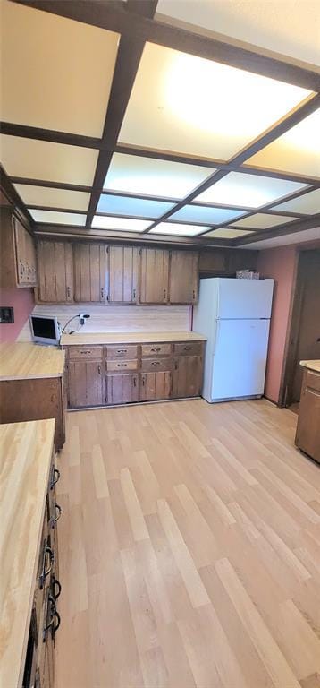 1117 Moose St, Yukon, OK 73099 - kitchen featuring freestanding refrigerator, light countertops, and light wood-type flooring