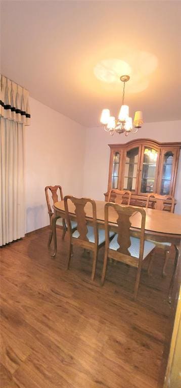 1117 Moose St, Yukon, OK 73099 - dining room featuring wood finished floors and a chandelier